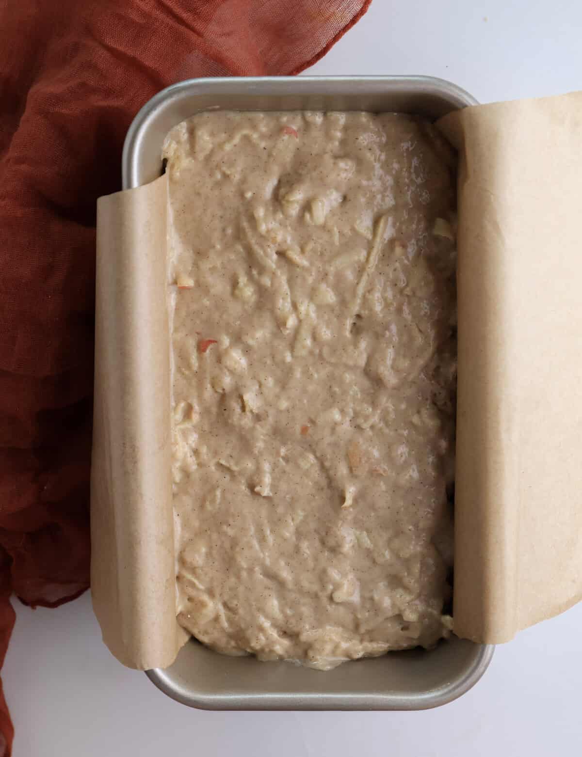 Apple bread batter in a loaf pan. 