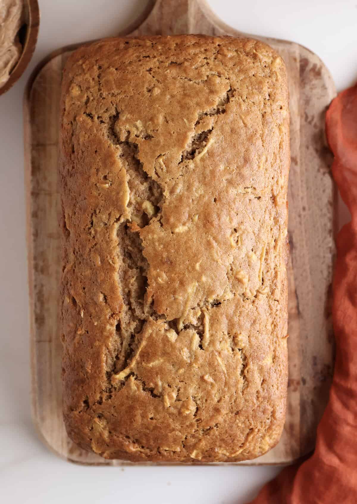 Apple bread loaf on a cutting board.