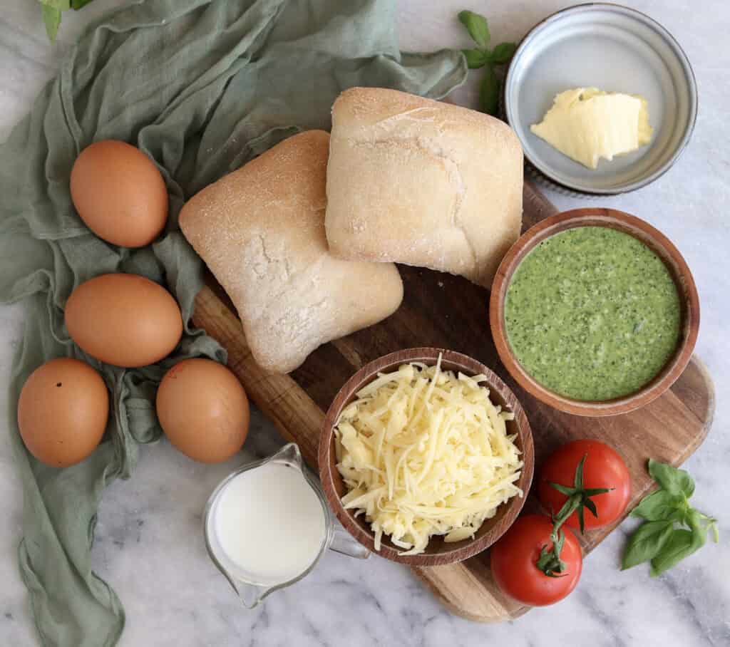 All the ingredients needed to make the spinach pesto egg sandwich on the counter.