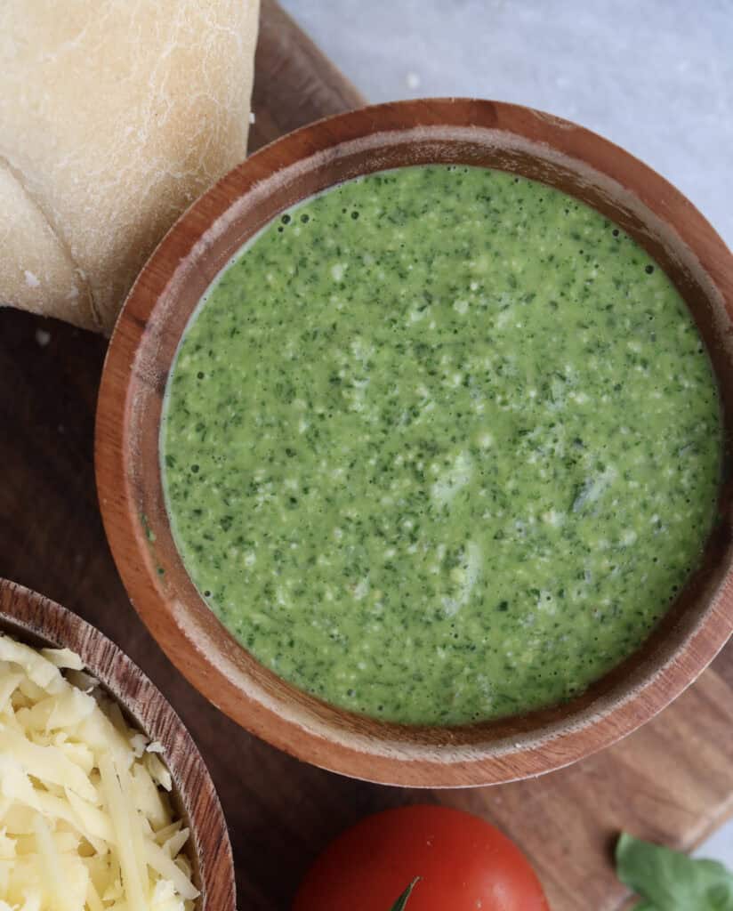 Up close of the spinach pesto in a wood bowl.