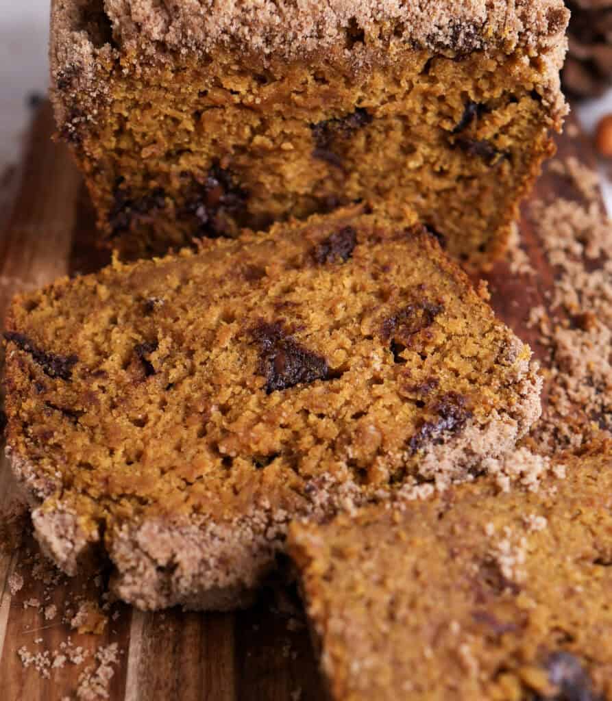 Slice of pumpkin chocolate chip bread on a cutting board. 
