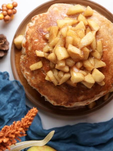 A stack of cottage cheese pancakes with the apple maple syrup on top.