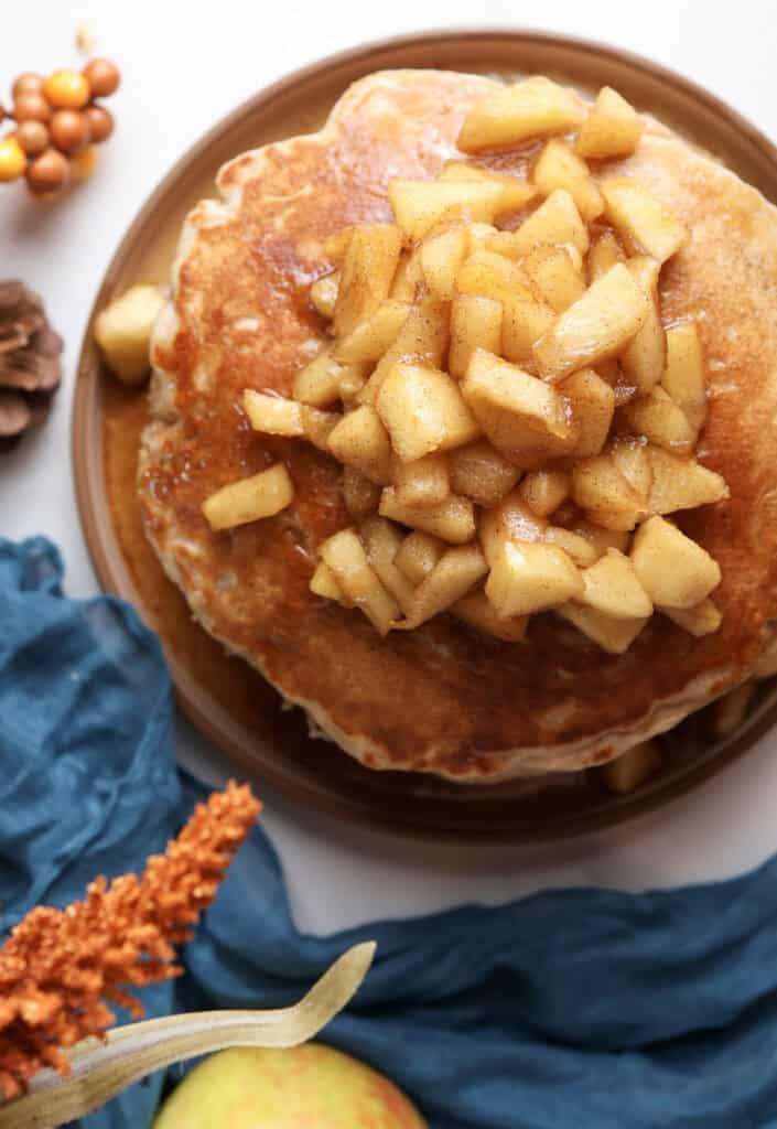A stack of cottage cheese pancakes with the apple maple syrup on top.