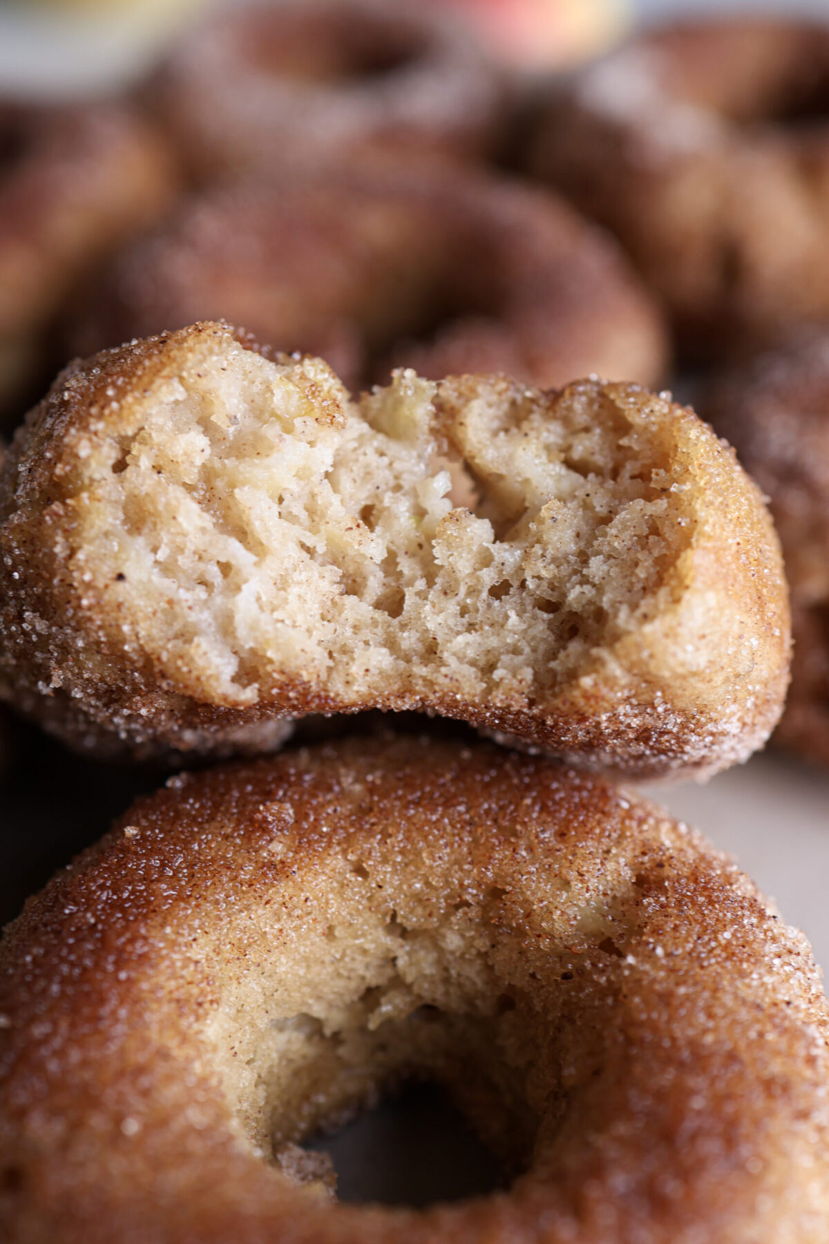Up close of apple baked donuts with bite.