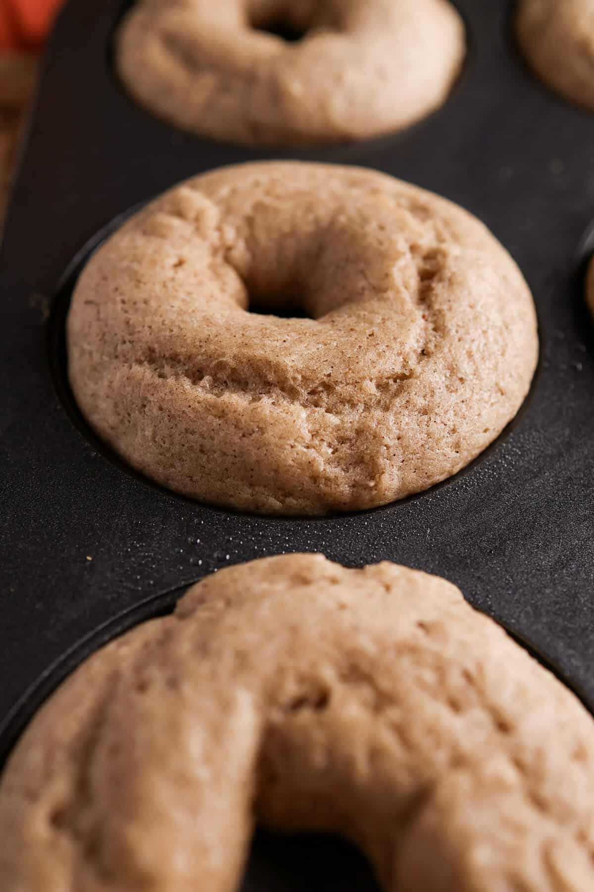 spiced baked donuts right out of the oven still in a donut pan.