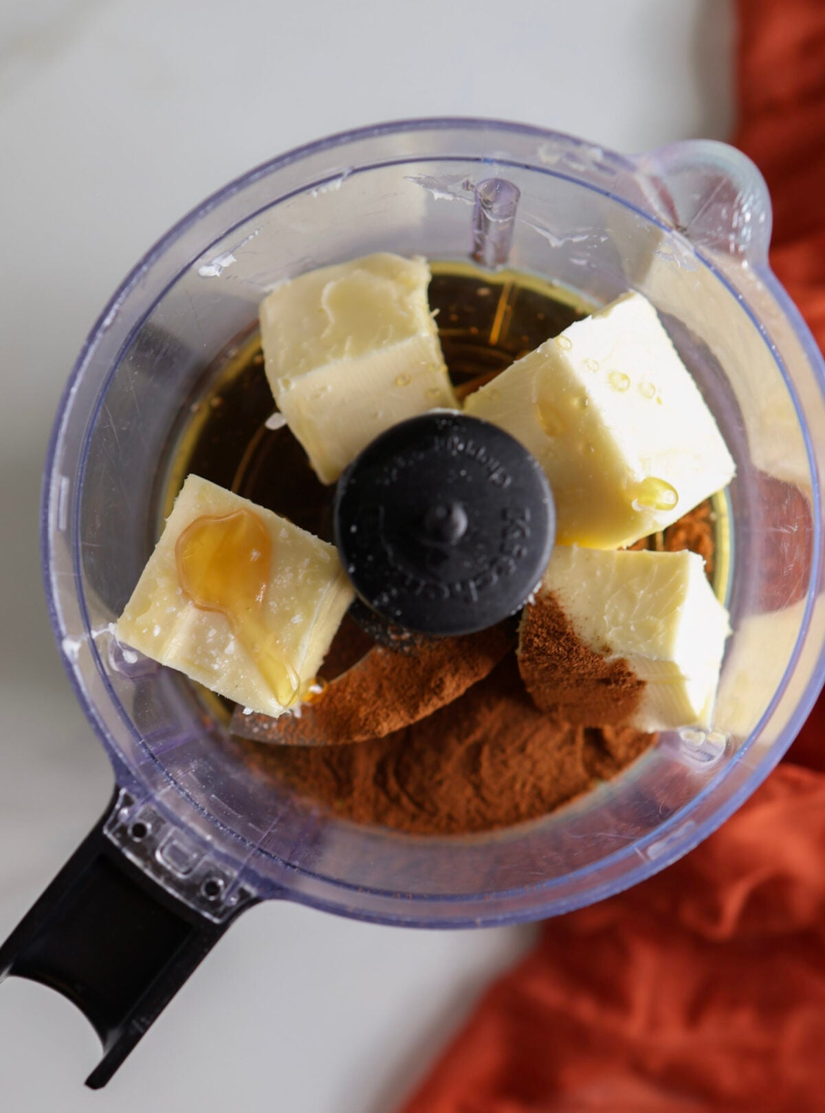 Ingredients for cinnamon honey butter in food processor. 