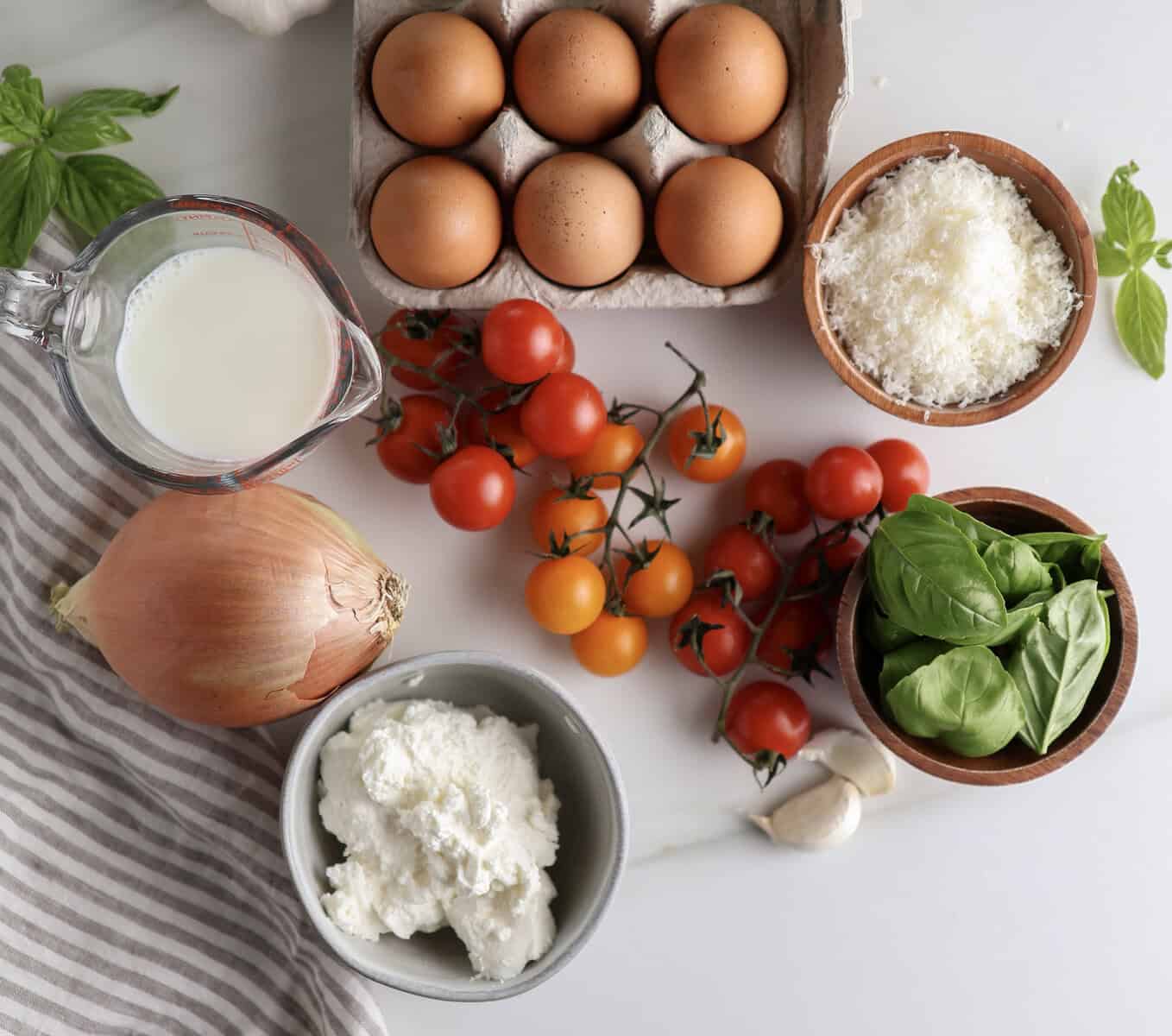 The ingredients for the ricotta egg bites with basil and tomatoes. 