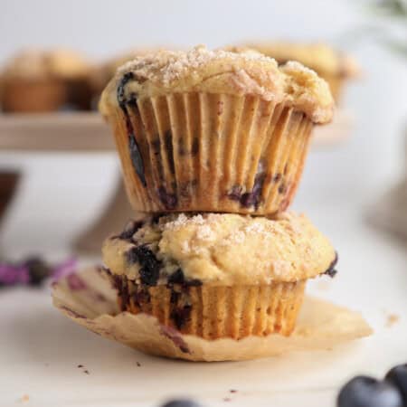 Brown Butter Blueberry Muffins stacked on each other.