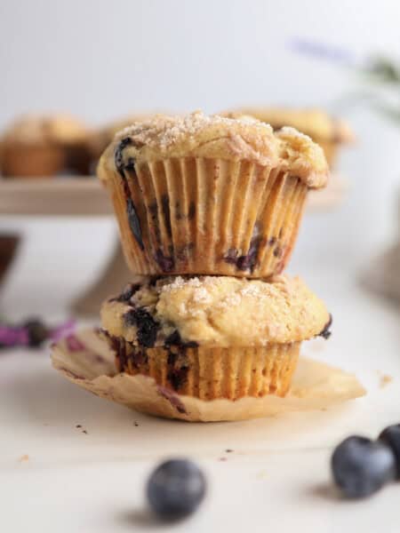 Brown Butter Blueberry Muffins stacked on each other.
