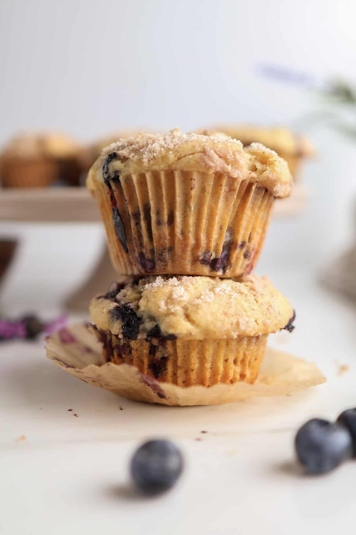 Brown Butter Blueberry Muffins stacked on each other.