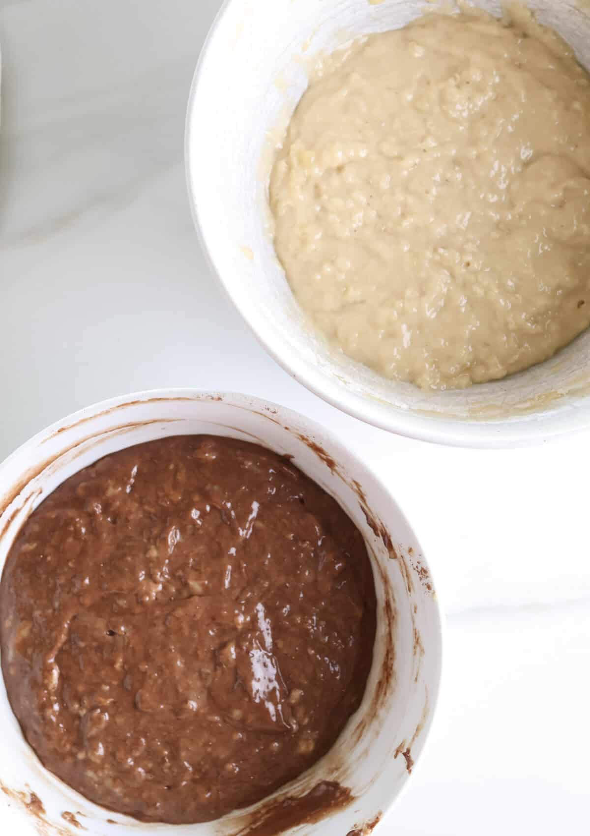 A bowl of chocolate banana batter and plain banana bread batter side-by-side