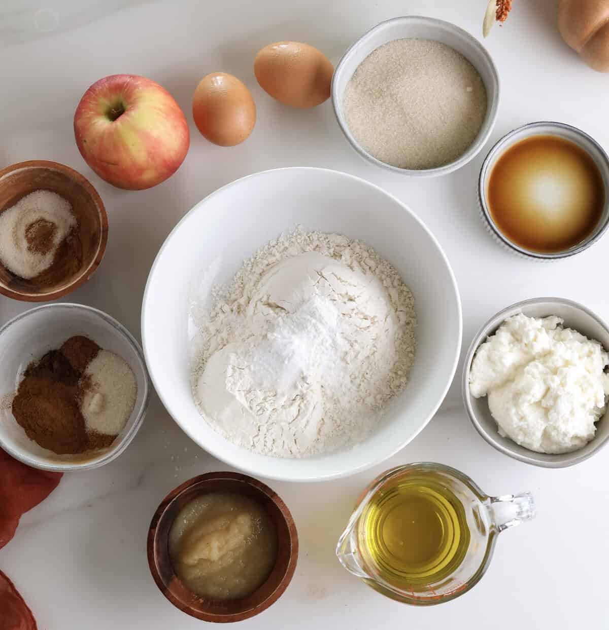 A photo of all the ingredients used to make the ricotta olive oil apple loaf cake.