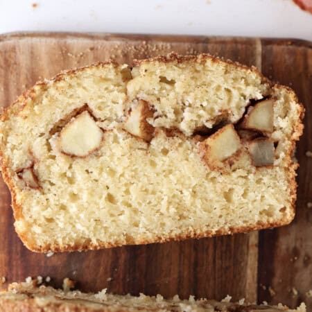 A slice of the apple loaf cake, showing the apple pieces in the center of the cake