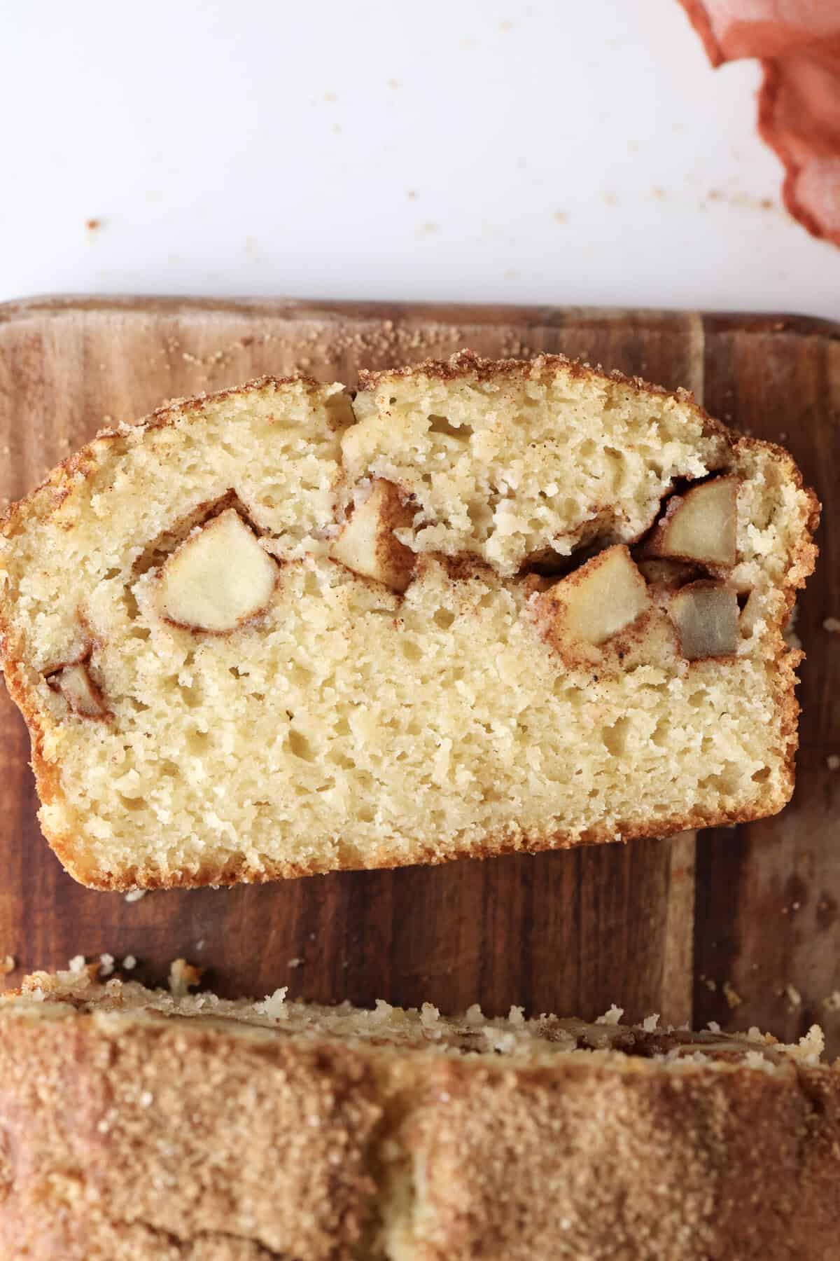 A slice of the apple loaf cake, showing the apple pieces in the center of the cake