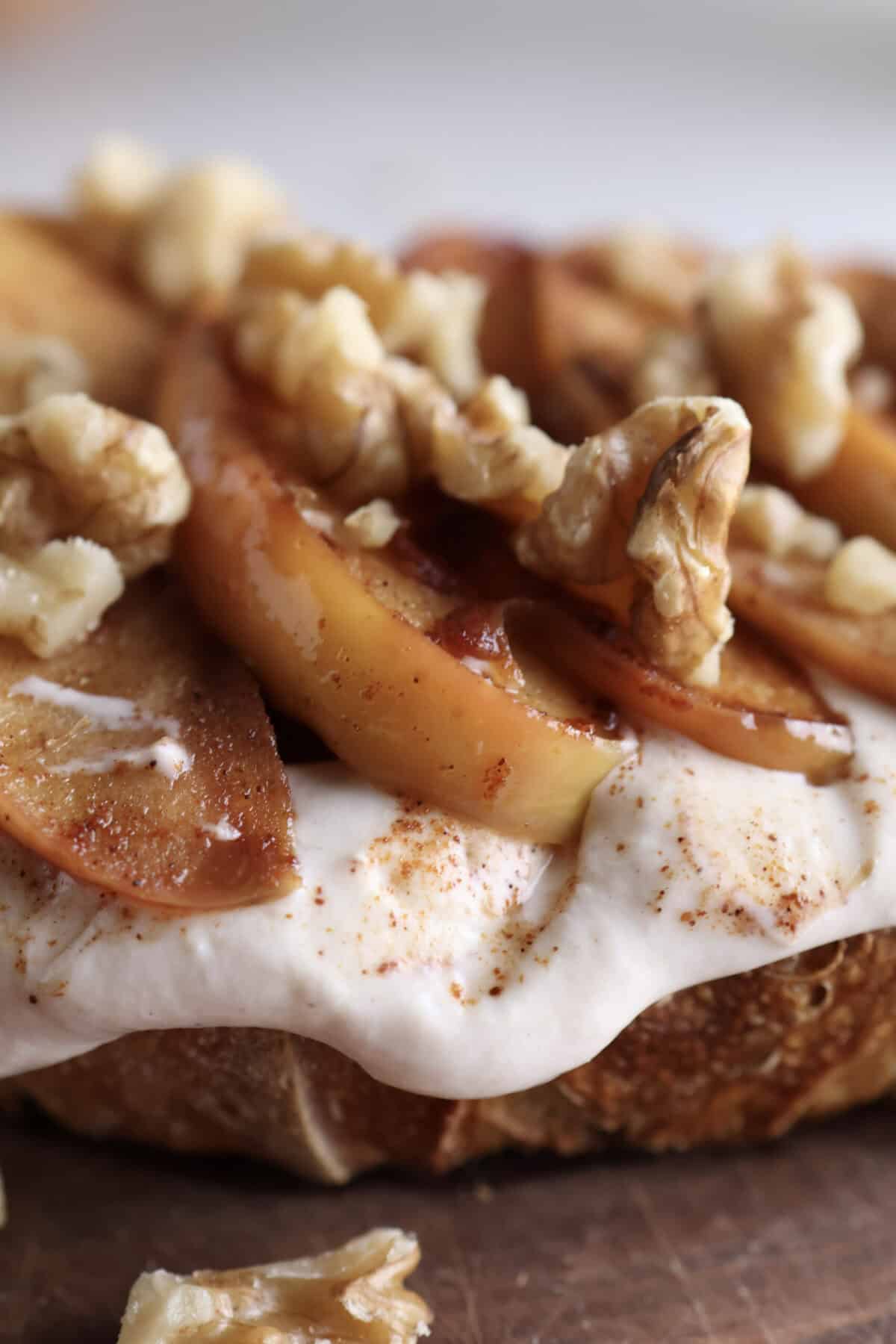 Up close shot of the Greek yogurt and cinnamon apples sitting on the sourdough toast.