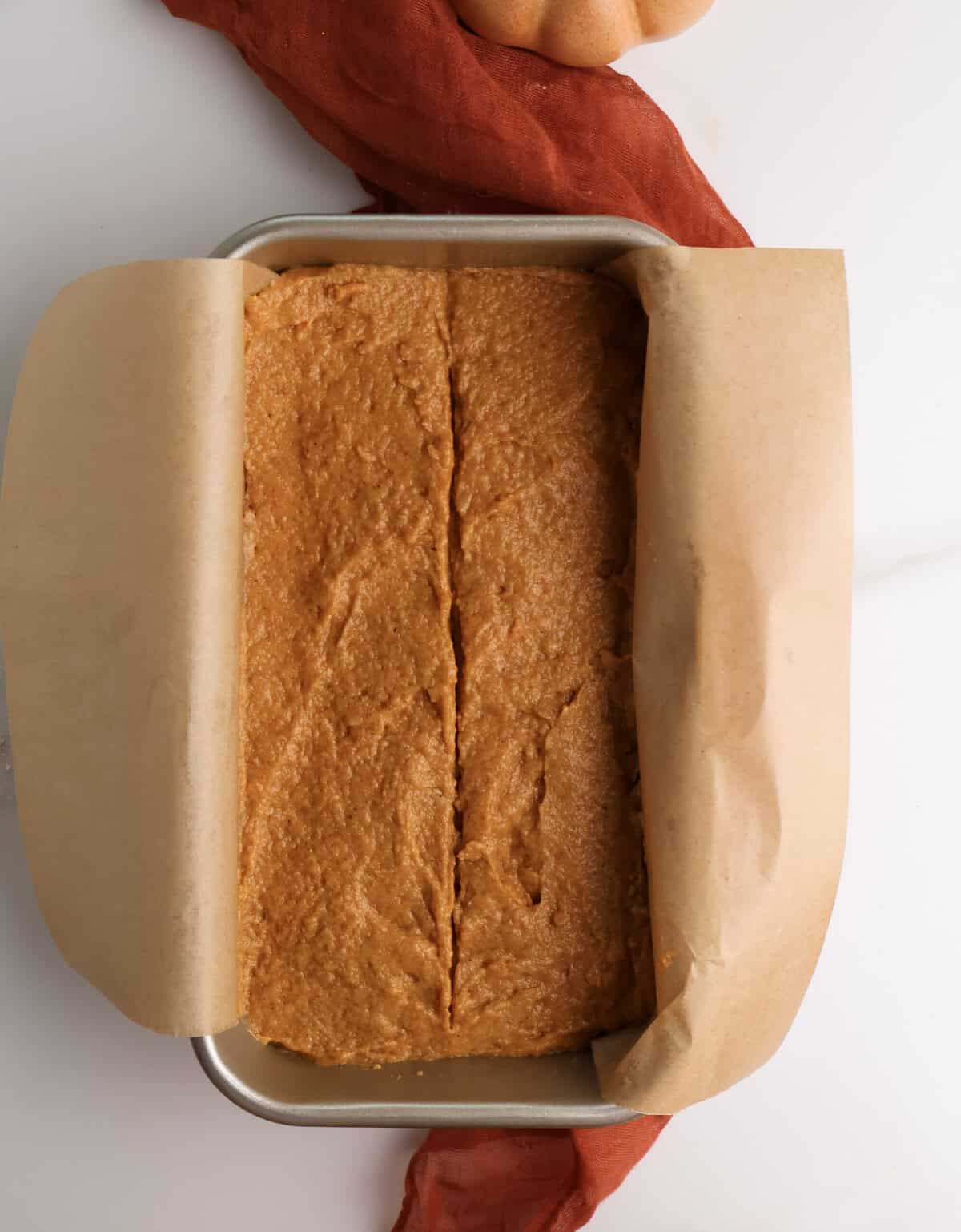 Spiced pumpkin bread batter in a loaf pan.