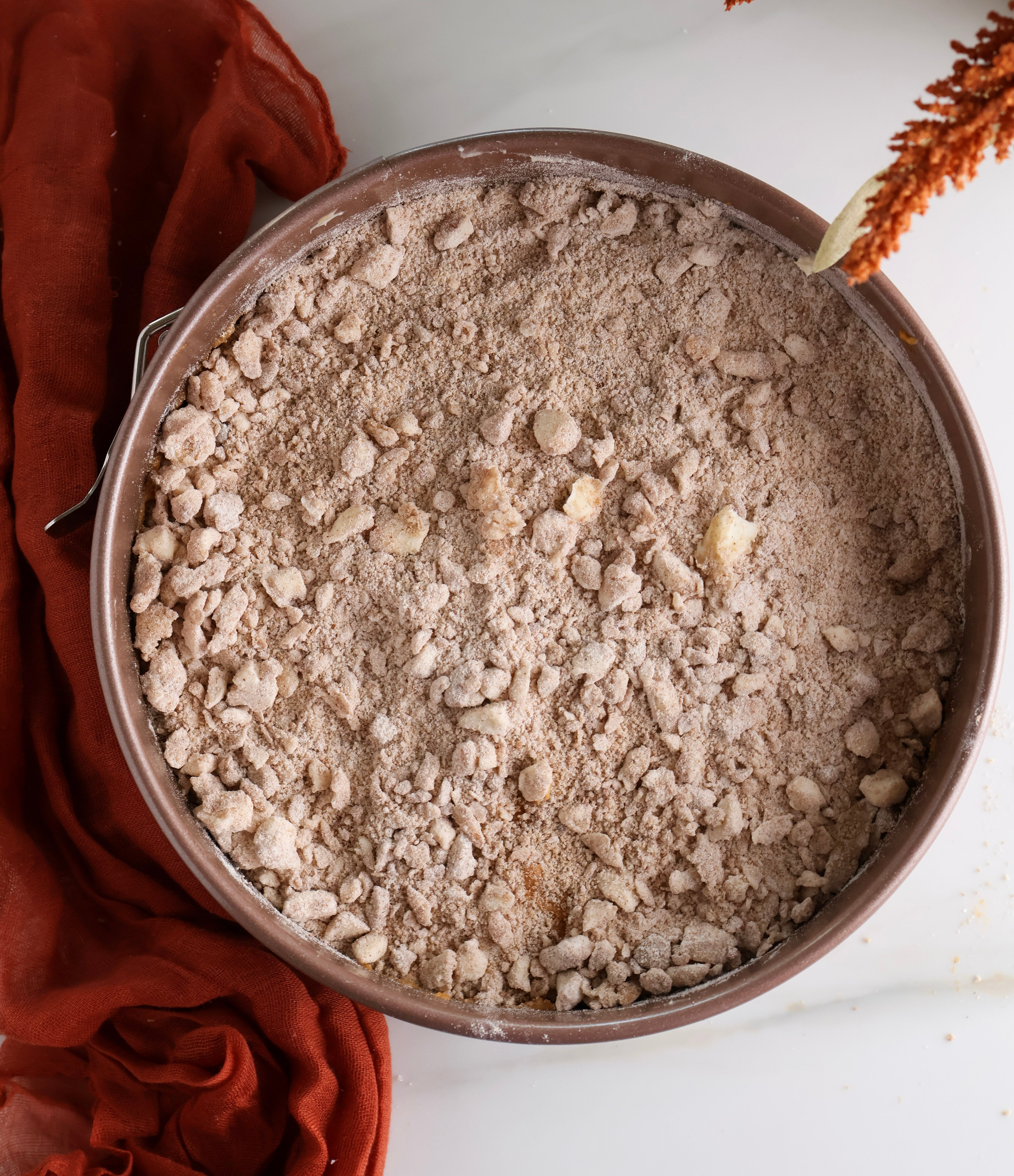 The unbaked pumpkin coffee cake with the crumb topping before going into the oven