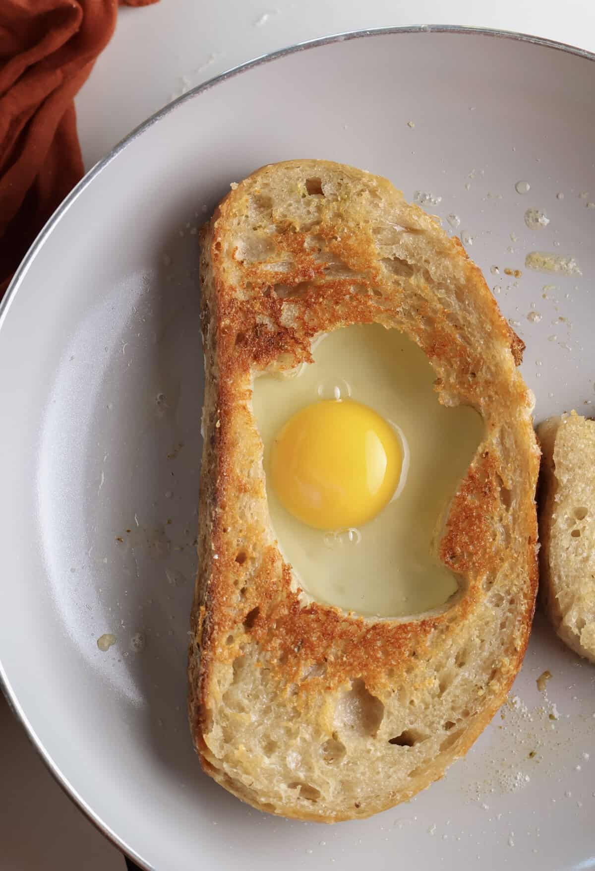The Halloween eggs in a hole cooking in the skillet