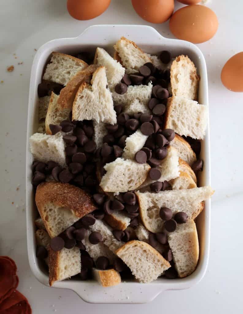 Sourdough pieces and chocolate chips in a baking dish.