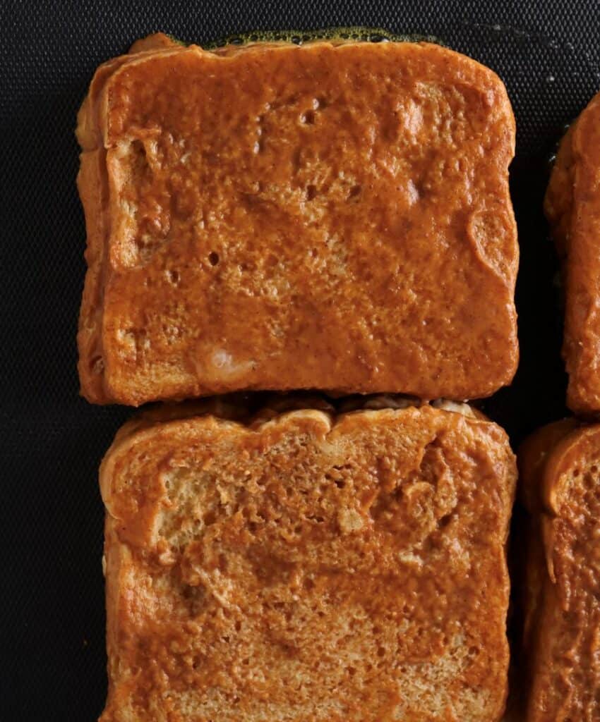 Pumpkin French toast cooking on the skillet. 