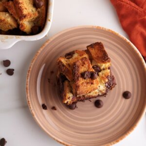 Overhead shot of a slice of the sourdough French toast casserole with chocolate chips.