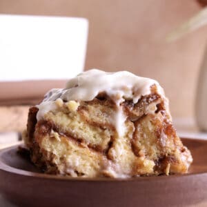 A slice of cinnamon roll brioche French Toast casserole.