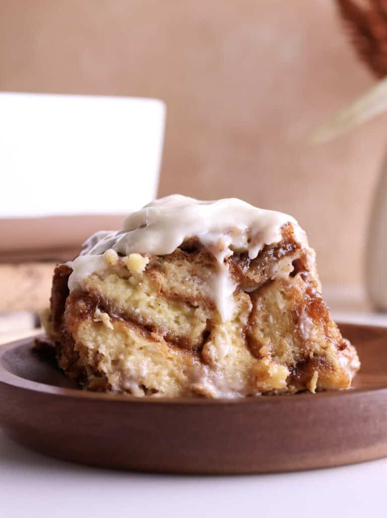 A slice of cinnamon roll brioche French Toast casserole.