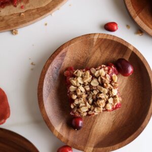 Cranberry and orange oat bars on plates.