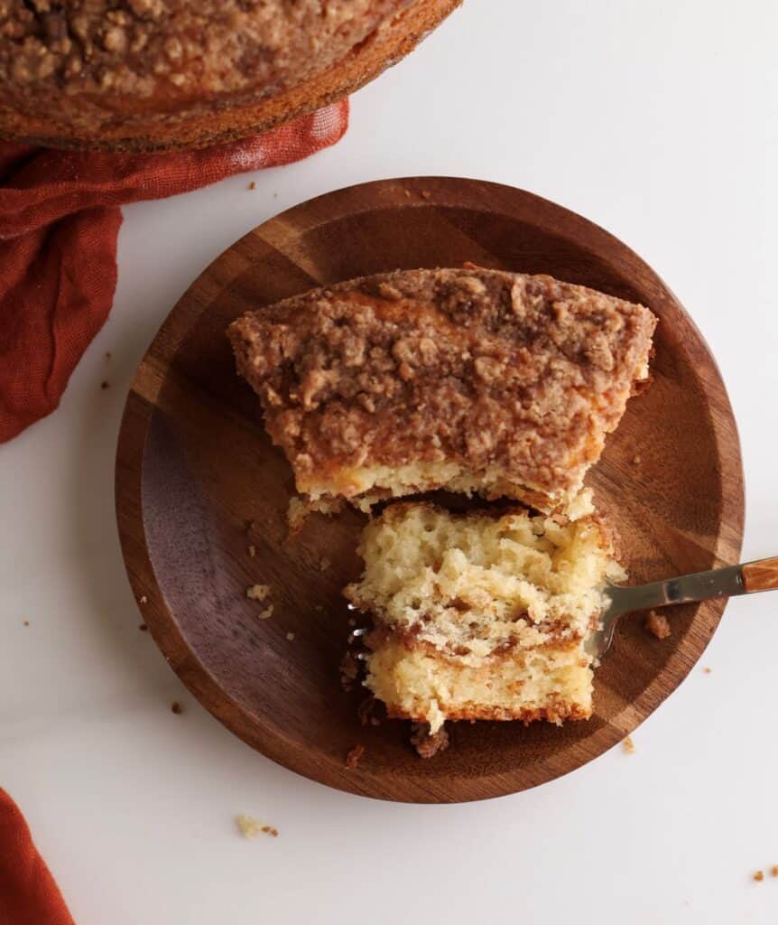 Overhead shot of a slice of sourdough coffee cake with a bite on a fork.