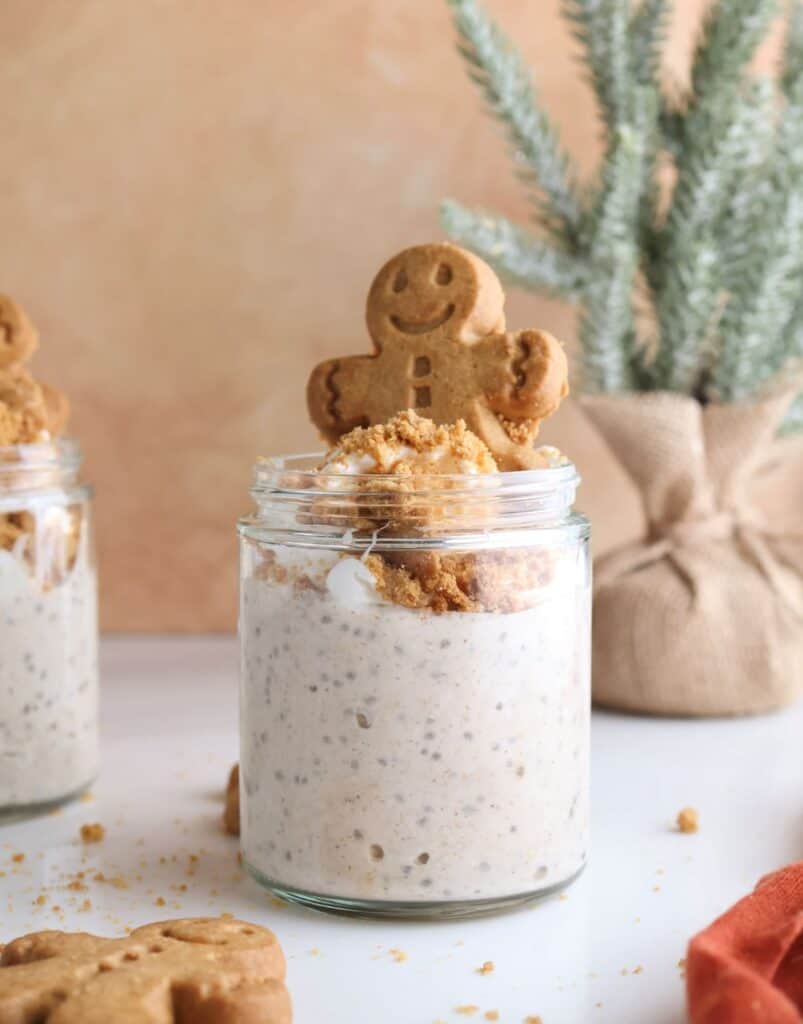 healthy gingerbread overnight oats in a jar with whipped cream. 