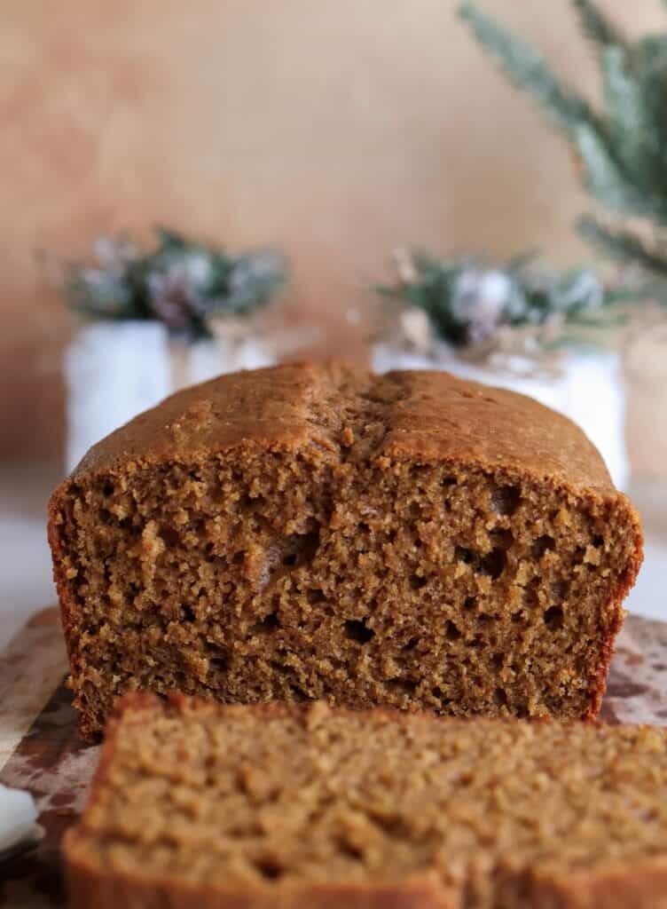 up close shot of the gingerbread loaf sliced on a cutting board. 