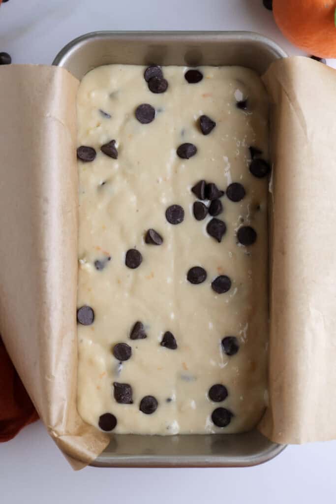 The orange loaf cake with chocolate chip batter in a loaf pan before going into the oven.