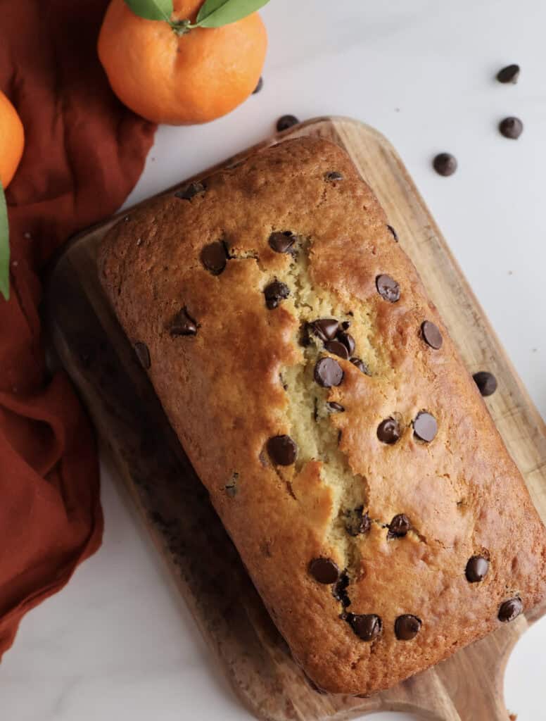 Orange and chocolate chip loaf on cutting board.