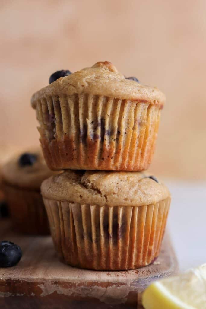Two protein lemon blueberry muffins stacked on each other.
