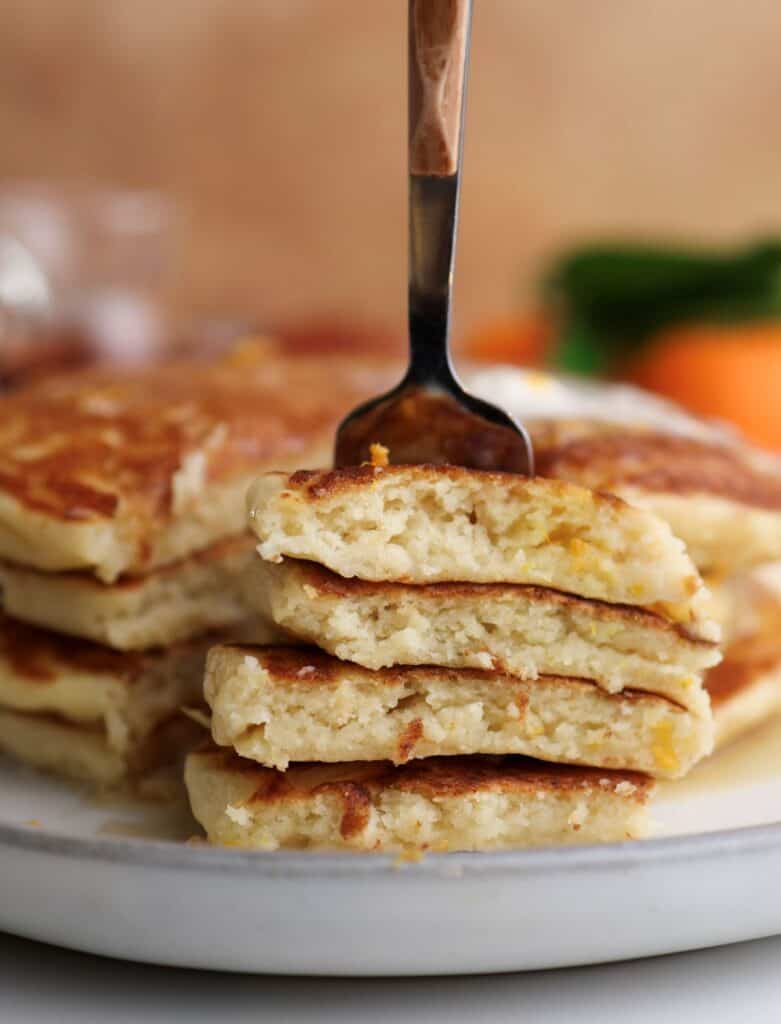 Up close shot of ricotta orange pancakes on a fork.
