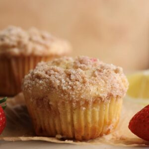 A strawberry lemon muffin on a muffin liner.