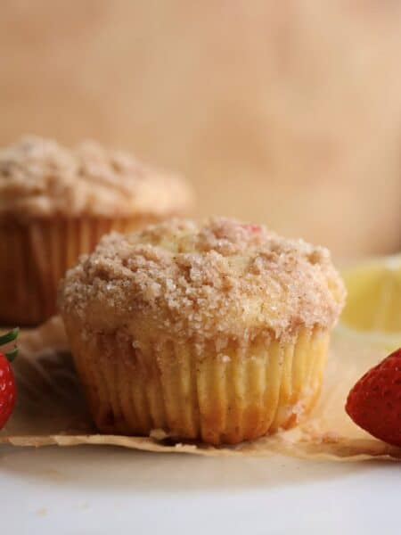 A strawberry lemon muffin on a muffin liner.