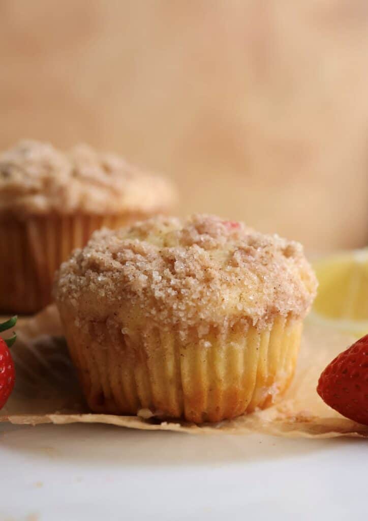 A strawberry lemon muffin on a muffin liner.