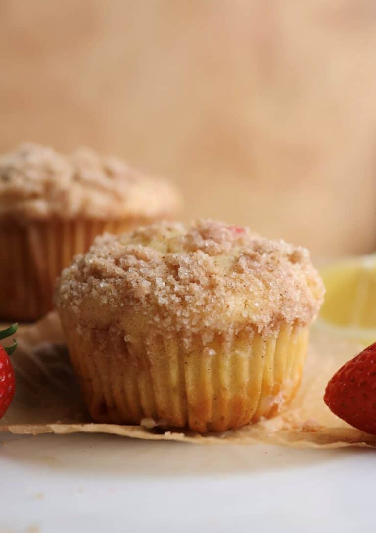 A strawberry lemon muffin on a muffin liner.