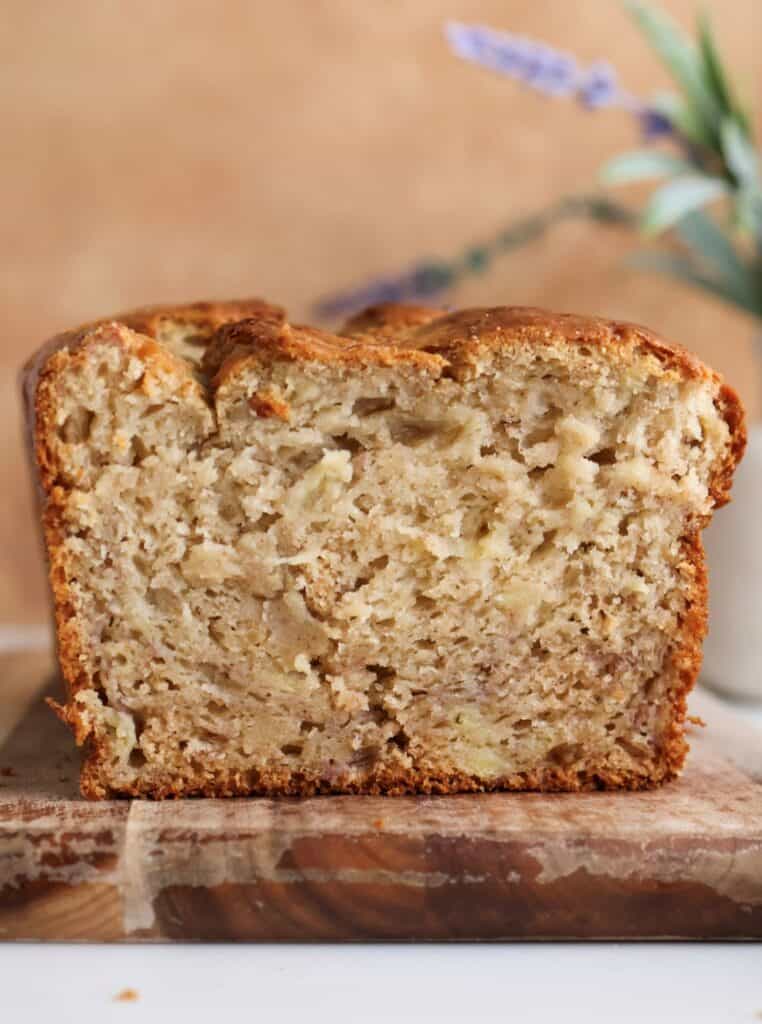 Sourdough discard banana bread cut into on a cutter board.