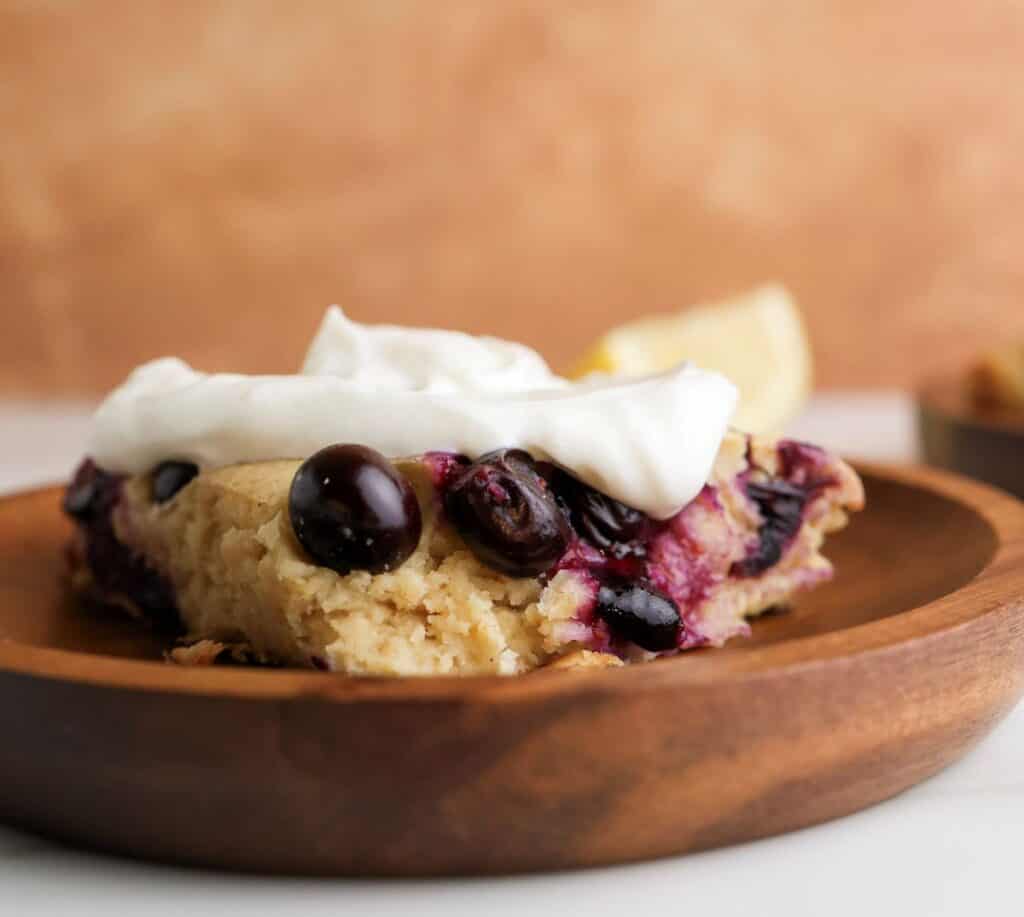 Slice of lemon blueberry blended baked oats with Greek yogurt on top. 