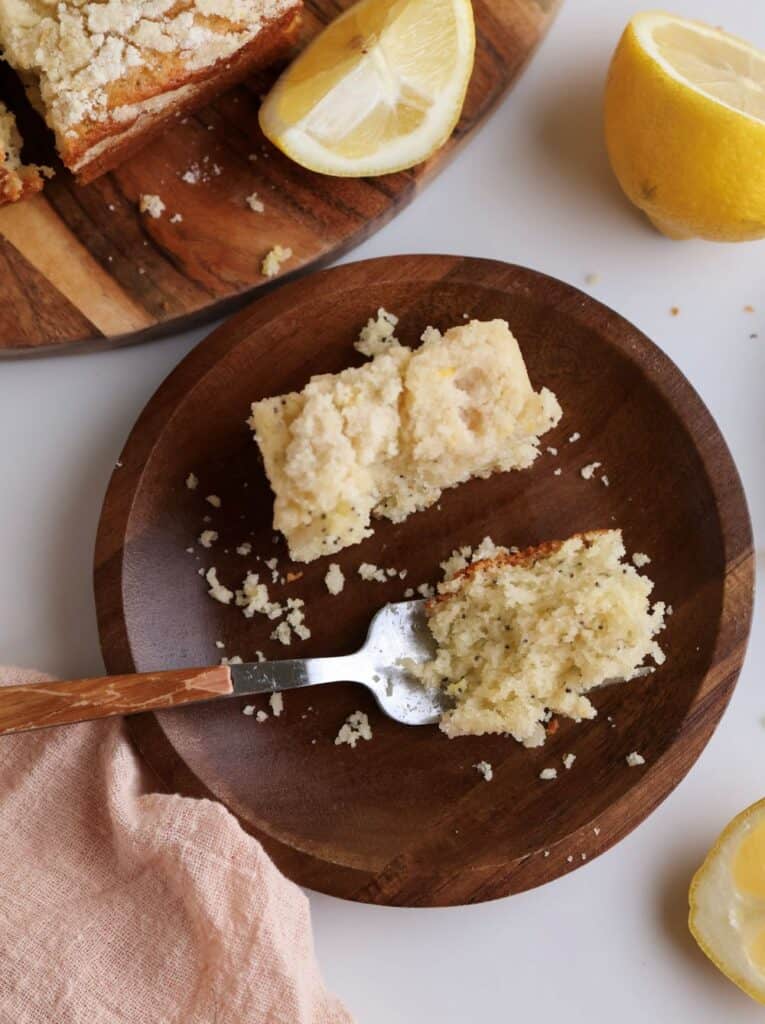 Slice of lemon poppyseed coffee cake with bite on a fork. 