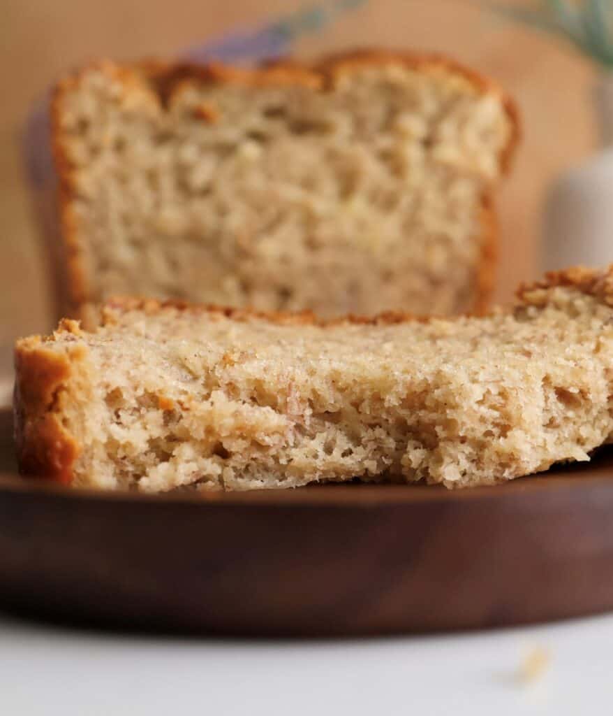 Up close shot of a slice of sourdough discard banana bread on a plate.