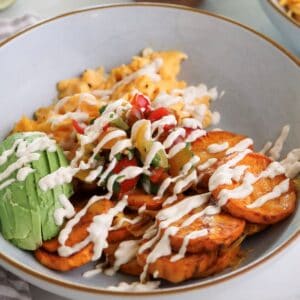 Sweet potato breakfast bowl with eggs and chipotle sauce.