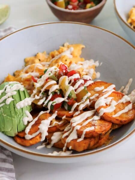 Sweet potato breakfast bowl with eggs and chipotle sauce.