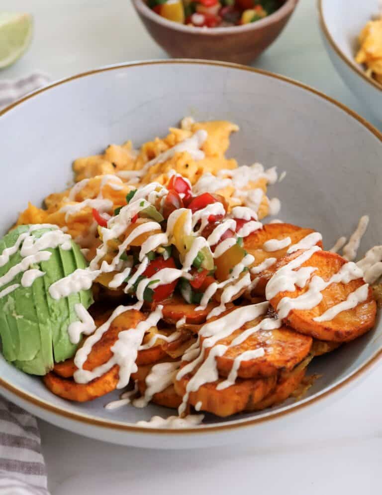 Sweet potato breakfast bowl with eggs and chipotle sauce.