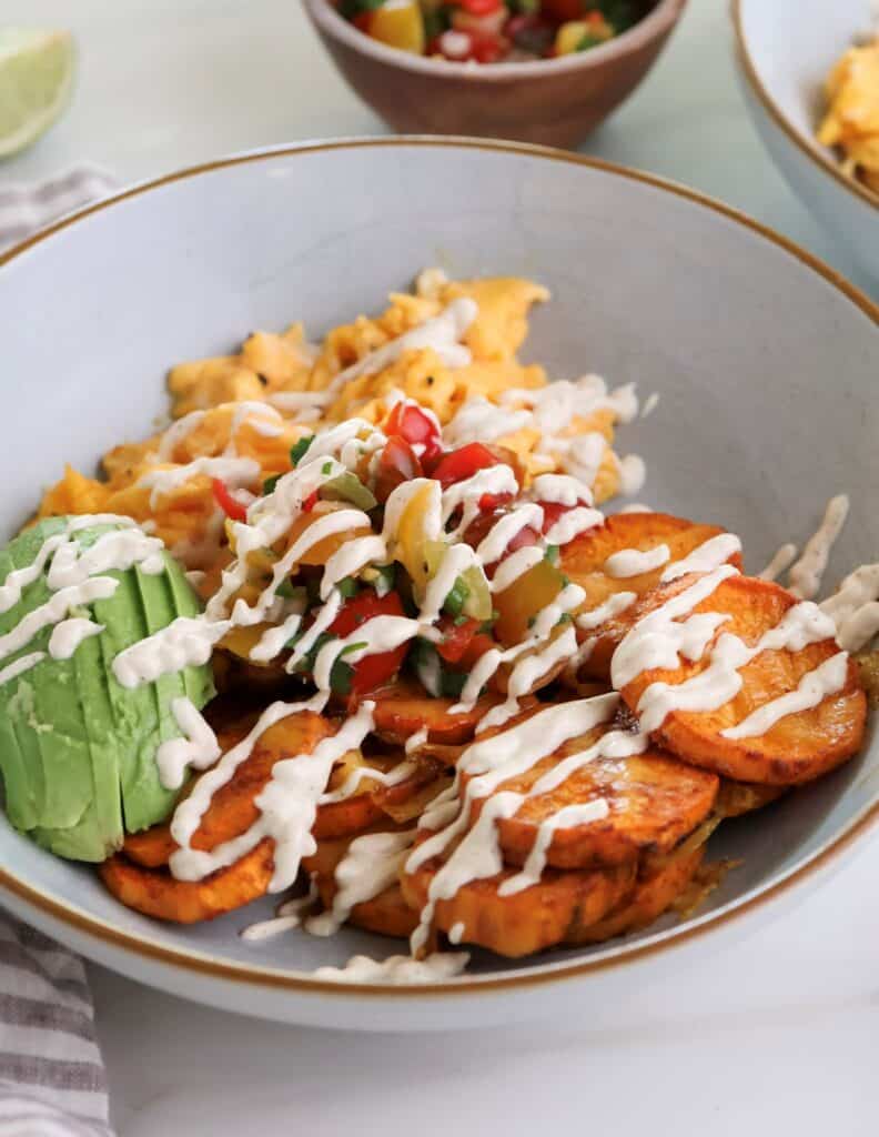 Sweet potato breakfast bowl with eggs and chipotle sauce.