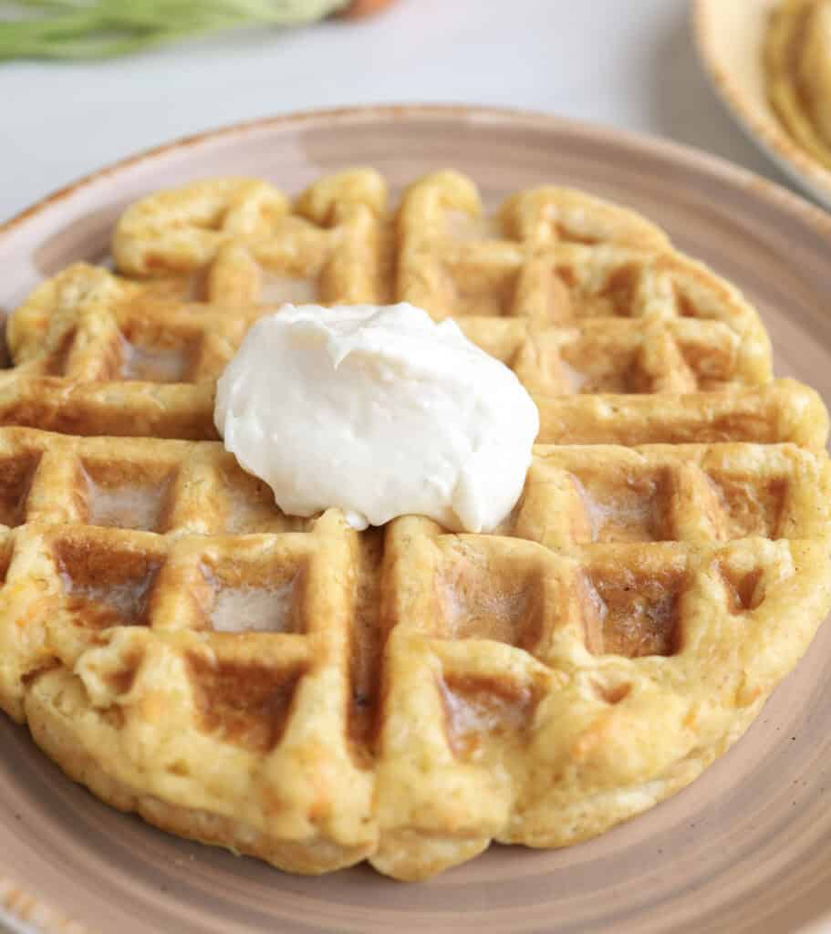 Up close of carrot cake waffle with maple cream cheese.