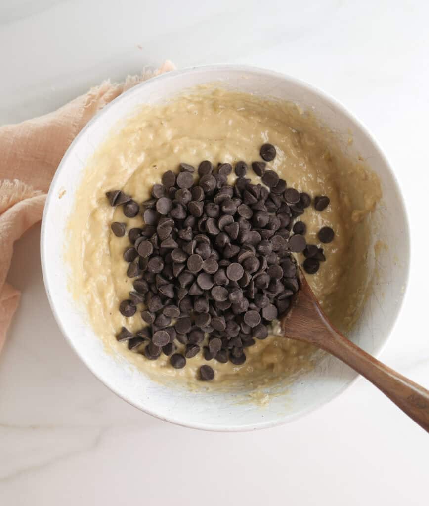 Banana bread batter with chocolate chips in a bowl.