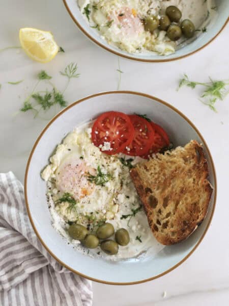 Savory Greek Yogurt Breakfast Bowls with Feta fried eggs, tomatoes, and olives.